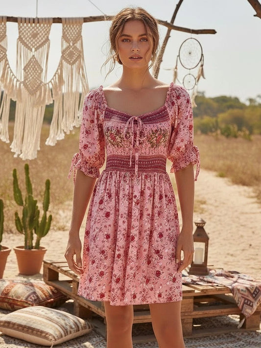 Pink floral print mini dress with smocked empire waist and tie-front neckline