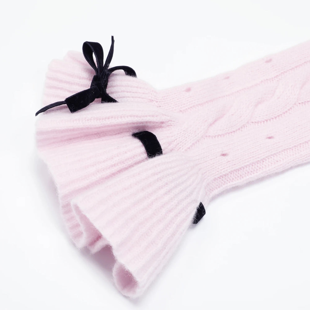 Detail of the flared cuff with black velvet bow on pink sweater