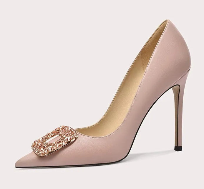 High-heeled shoe with decorative buckle on a light gray background