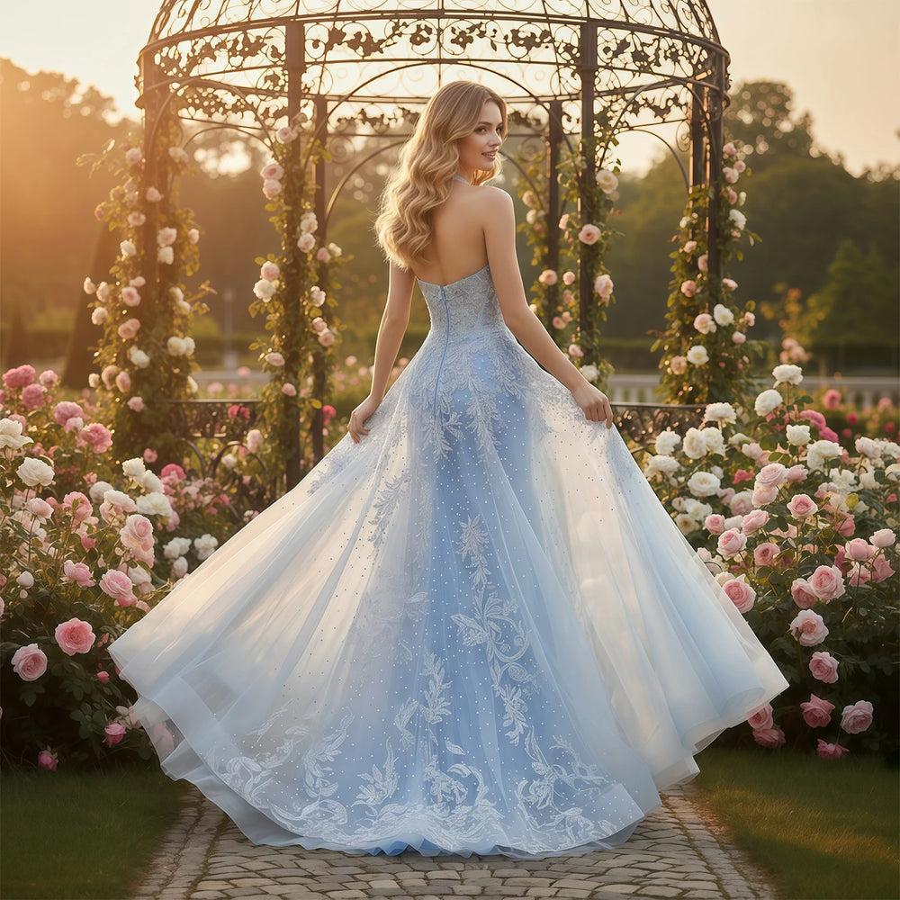 Woman in a blue and white lace dress standing in a garden with floral arches.