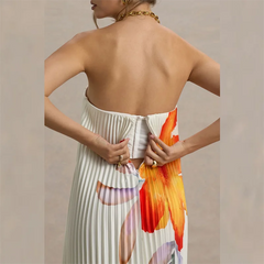 Woman wearing a colorful dress with abstract patterns on a beige background