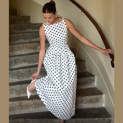 Woman in a polka dot dress descending a staircase