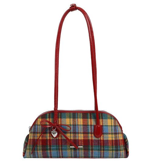 Red and yellow plaid pattern shoulder bag with red patent handles and a silver heart charm.
