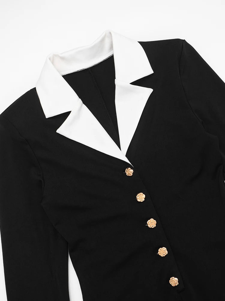 Black tuxedo jacket with white shirt collar and gold buttons 