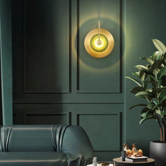 The Golden Atelier Modern Wall Sconce illuminating a hallway, creating a warm and inviting atmosphere. C