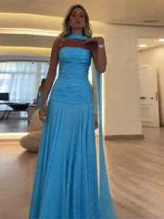Woman wearing a blue evening gown in an indoor setting