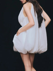 Woman wearing a white dress against a black background