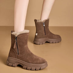 A woman's feet comfortably nestled in a pair of suede snow boots, perfect for snowy weather.