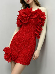 Strapless ruffled floral mini dress leaning against a wall