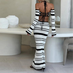 Person wearing a black and white striped outfit in a modern interior setting.