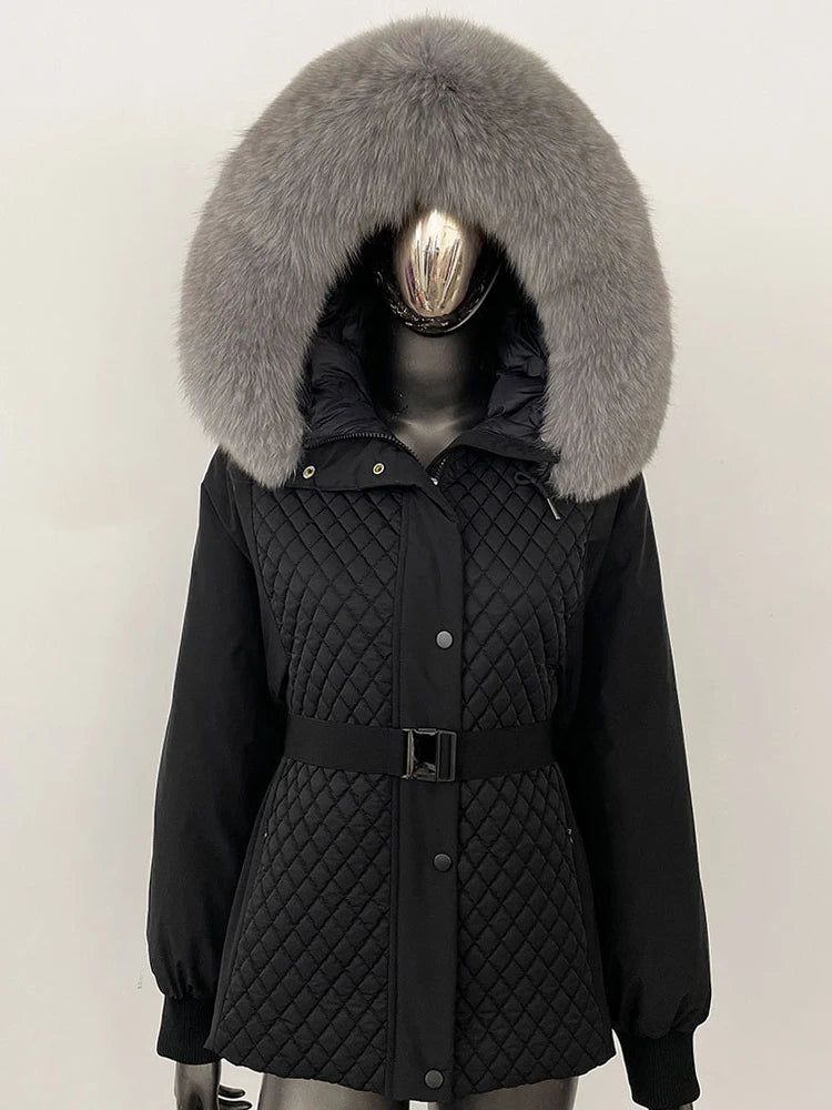 Black quilted jacket with a large fur hood on a mannequin against a white background