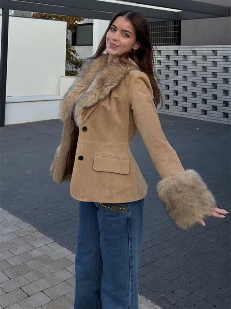Woman wearing a beige coat with fur trim outdoors