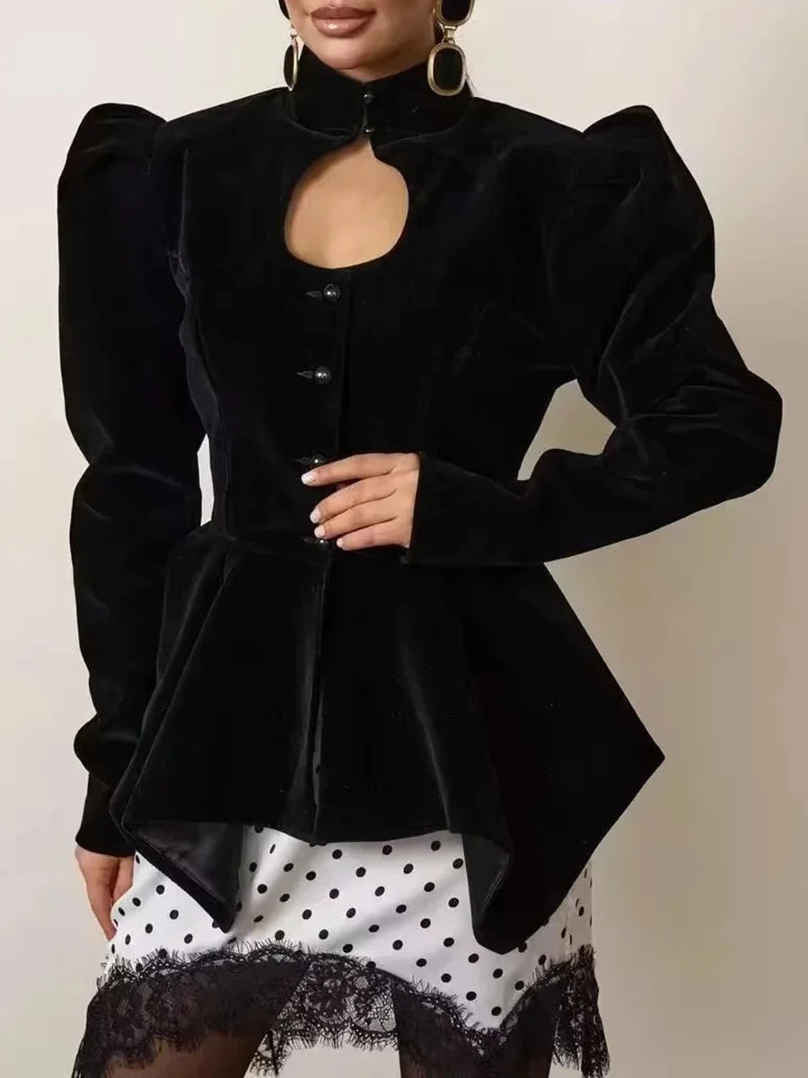 Black velvet peplum jacket with a circular cutout at the neckline and voluminous puffed sleeves.