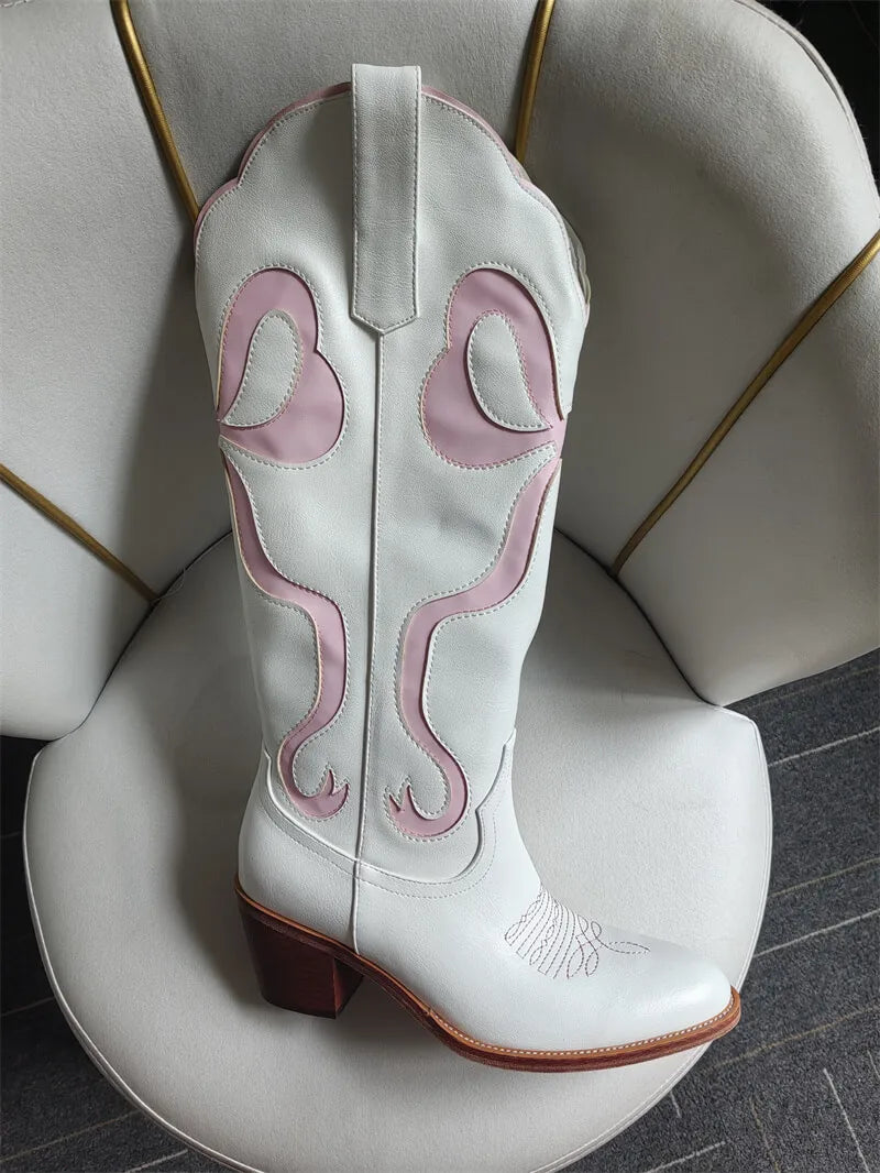 White cowboy boot with pink stitching on a white chair