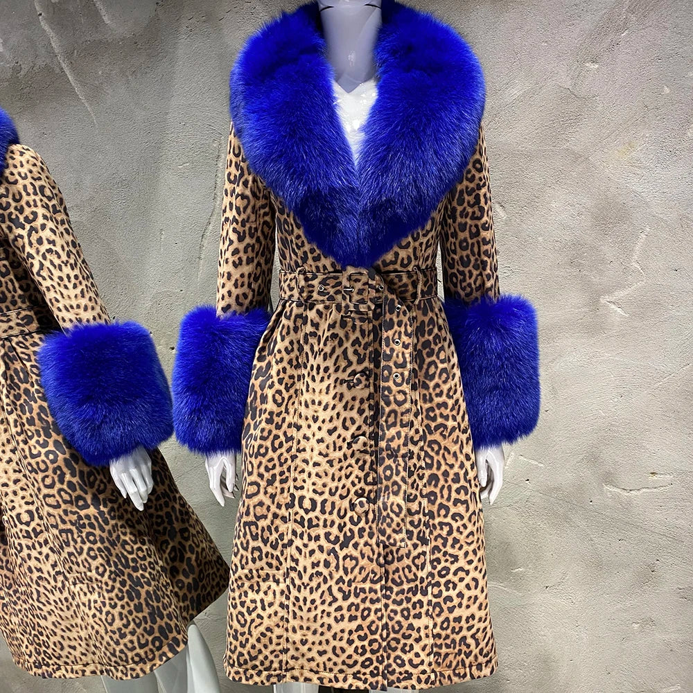 Leopard print coat with blue fur trim on a gray background