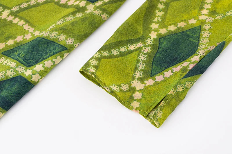 Detail of the long sleeve cuff on the midi dress with diamond pattern.