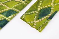 Detail of the long sleeve cuff on the midi dress with diamond pattern.