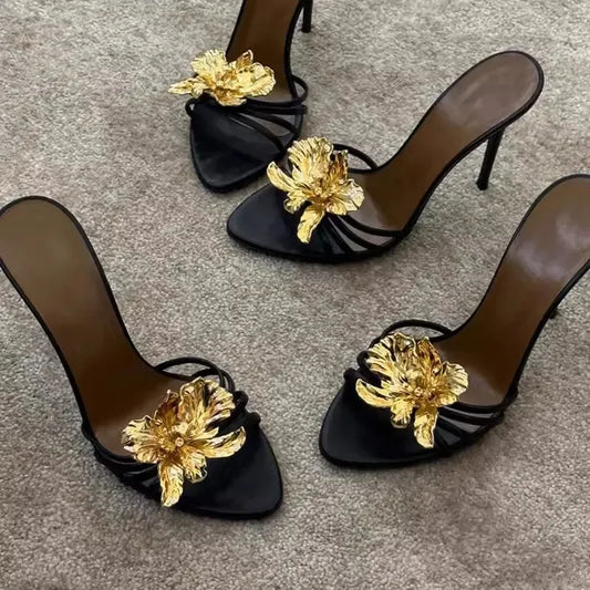 Black stiletto heels with gold floral embellishment