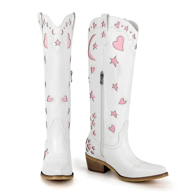 White cowboy boots with pink heart and star patterns on a white background