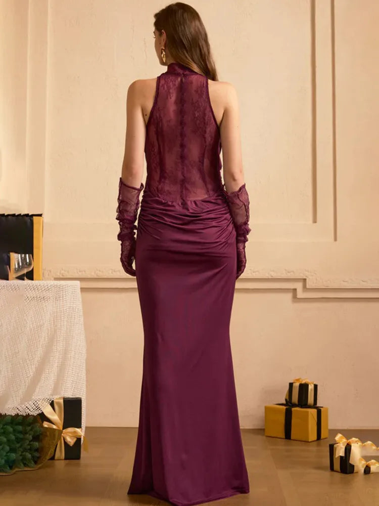 Woman wearing a long purple dress with gloves in an elegant room setting.