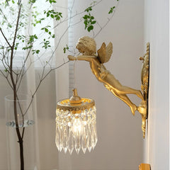 A luxurious crystal wall lamp with a French bronze angel design, casting a warm glow in a living room .Golden Atelier  2