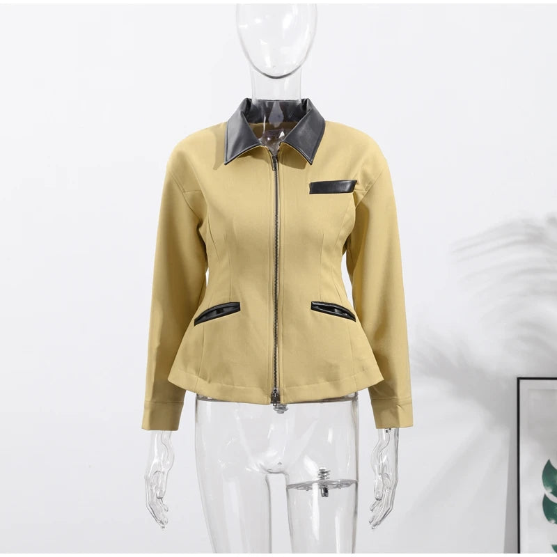 Beige jacket with black accents on a mannequin against a white background