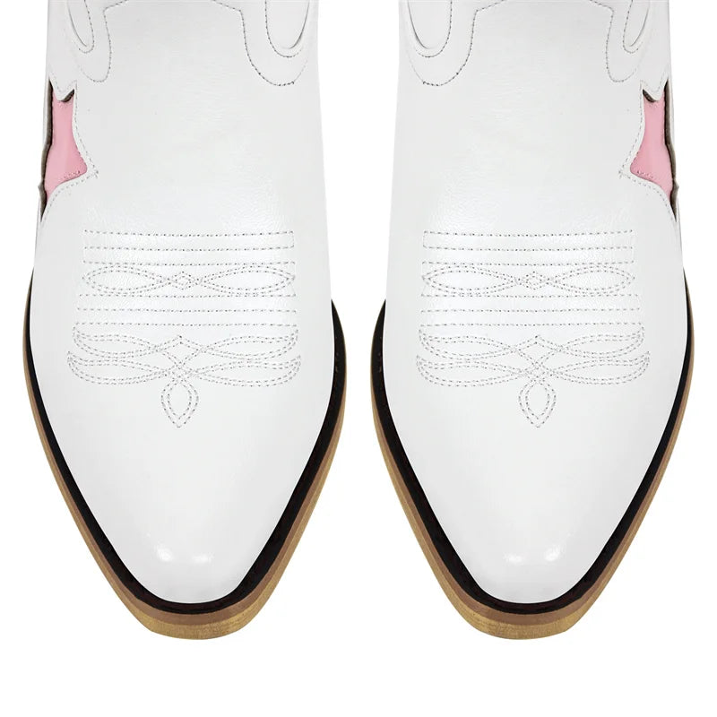White shoes with pink accents and black soles on a white background