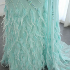 Close-up of the feather cape detailing and one-shoulder design on the turquoise mermaid gown.  Golden Atelier 4