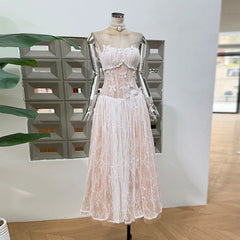 Lace dress on a mannequin against a neutral background