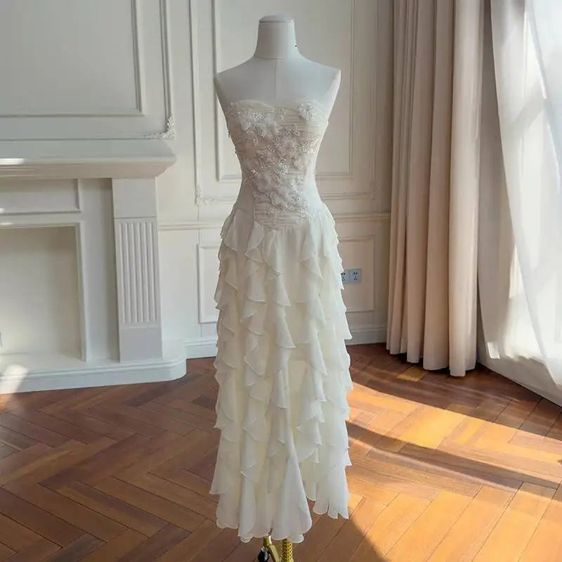 Full-length view of a strapless formal maxi dress with a ruffled skirt