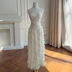 Full-length view of a strapless formal maxi dress with a ruffled skirt