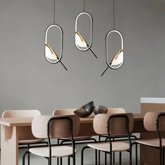  Nordic bird pendant lamp with black and silver finish, hanging in a cozy dining-room setting. Golden Atelier 2