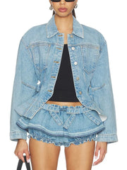 Model wearing a denim peplum jacket with belt and ruched shorts, showing torso