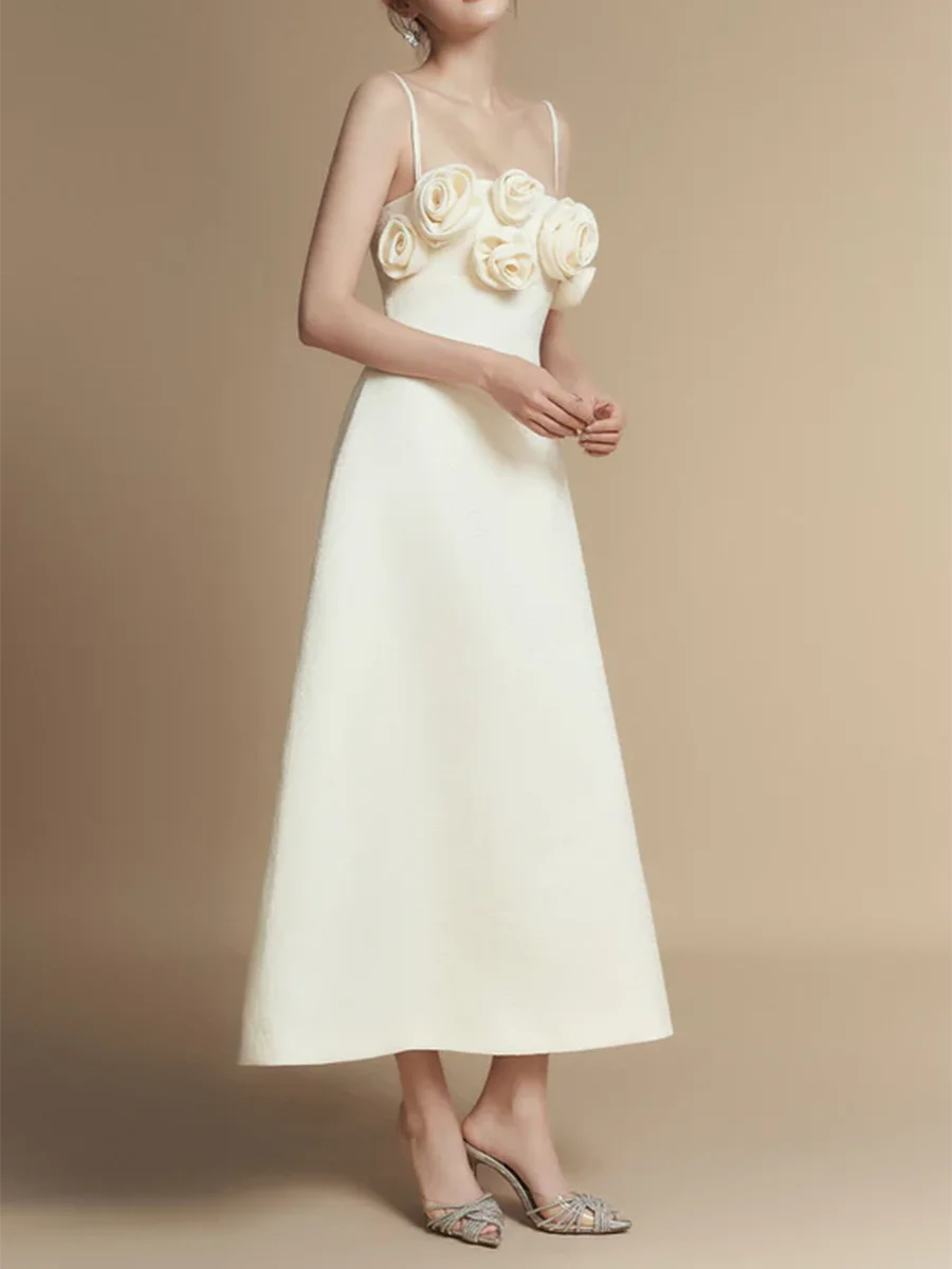 White dress with floral embellishments on a beige background