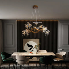 Modern dining room with a decorative chandelier, table, and chairs.