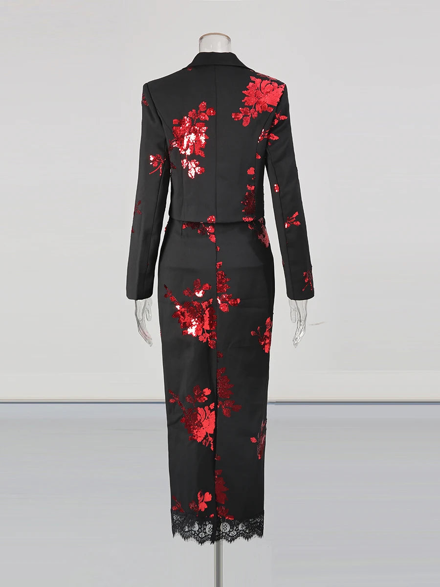 Black dress with red floral patterns on a mannequin against a white background