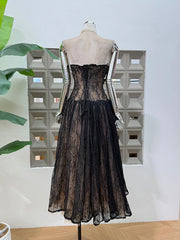 Black lace dress on a mannequin against a light background