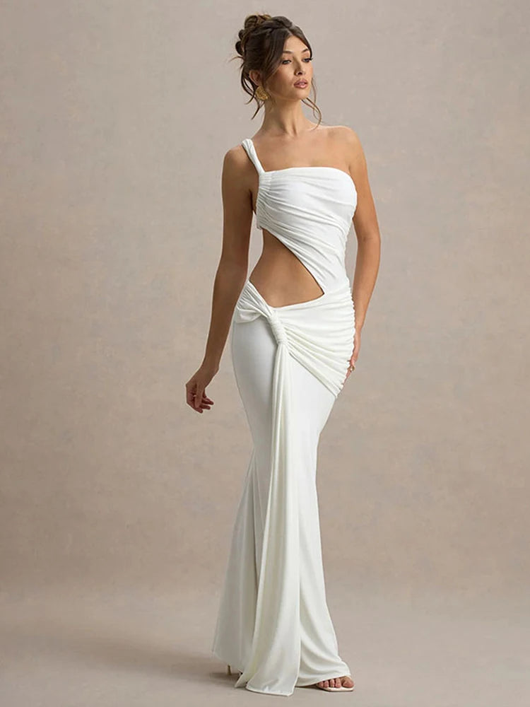 Woman wearing a white one-shoulder gown with a cutout design on a beige background