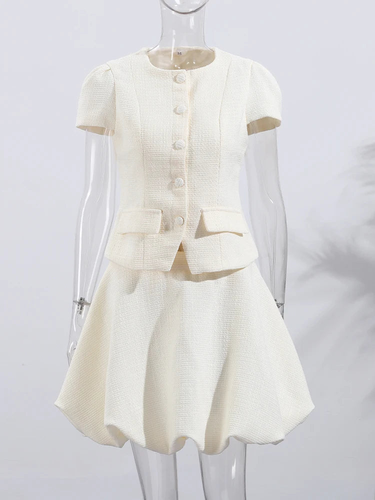 White dress with a jacket on a mannequin against a white background