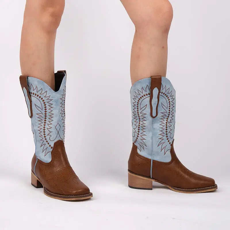 Model wearing embroidered square toe block heel boots