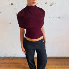 Burgundy draped turtleneck short sleeve cropped top with black pants