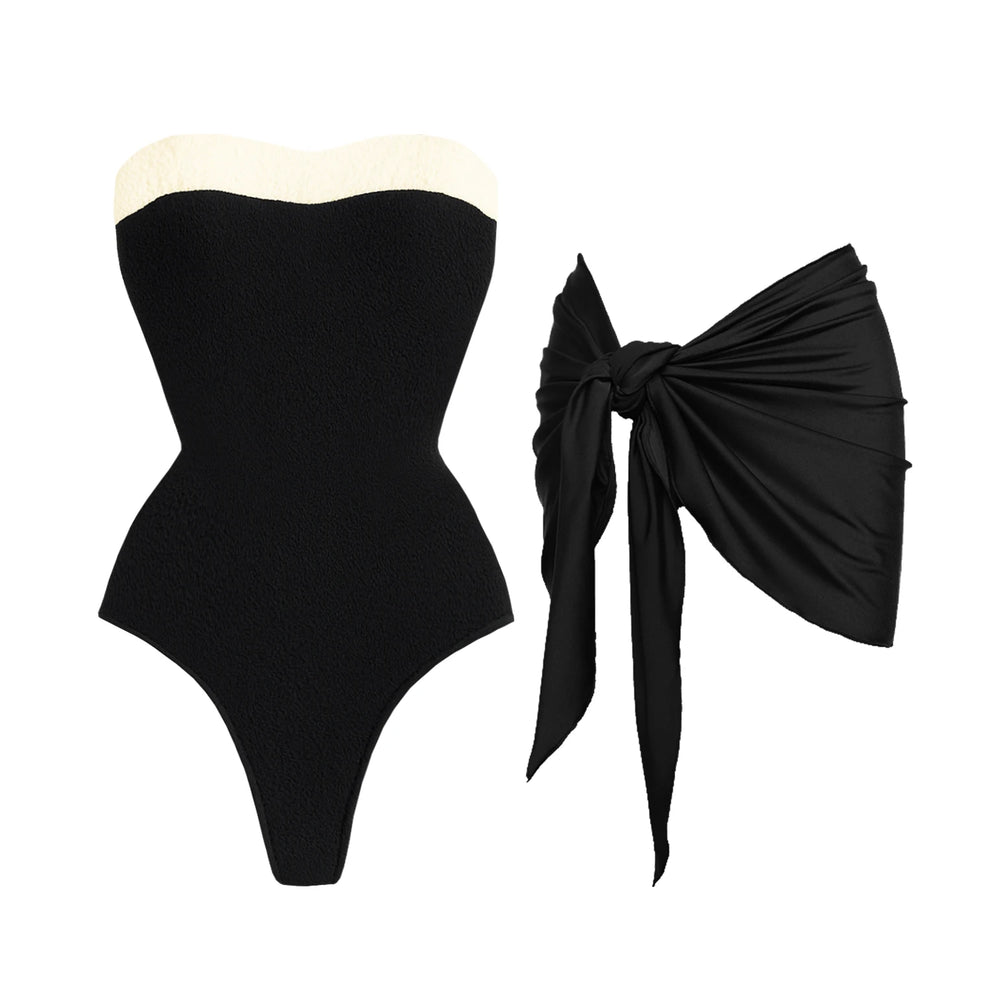 Textured black swimsuit with cream trim and black sarong.