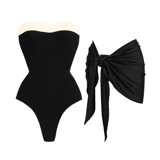 Textured black swimsuit with cream trim and black sarong.