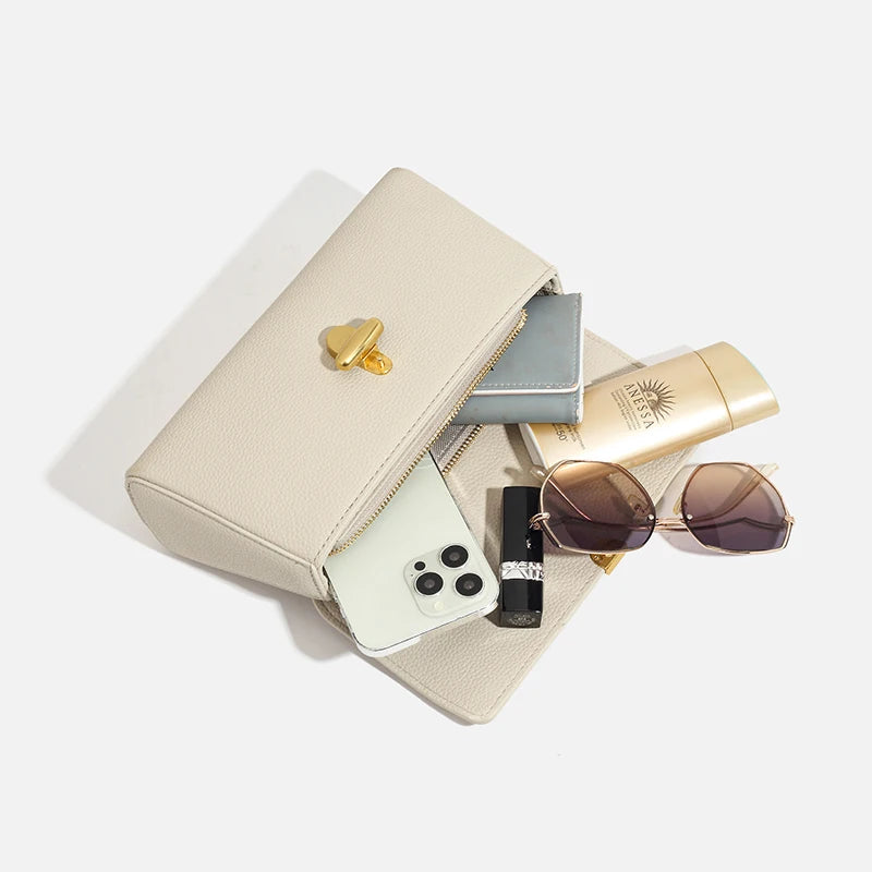 Open cream genuine leather shoulder bag showing contents