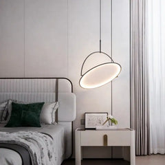 A sleek, modern LED pendant light hanging above a bed room side table 2 