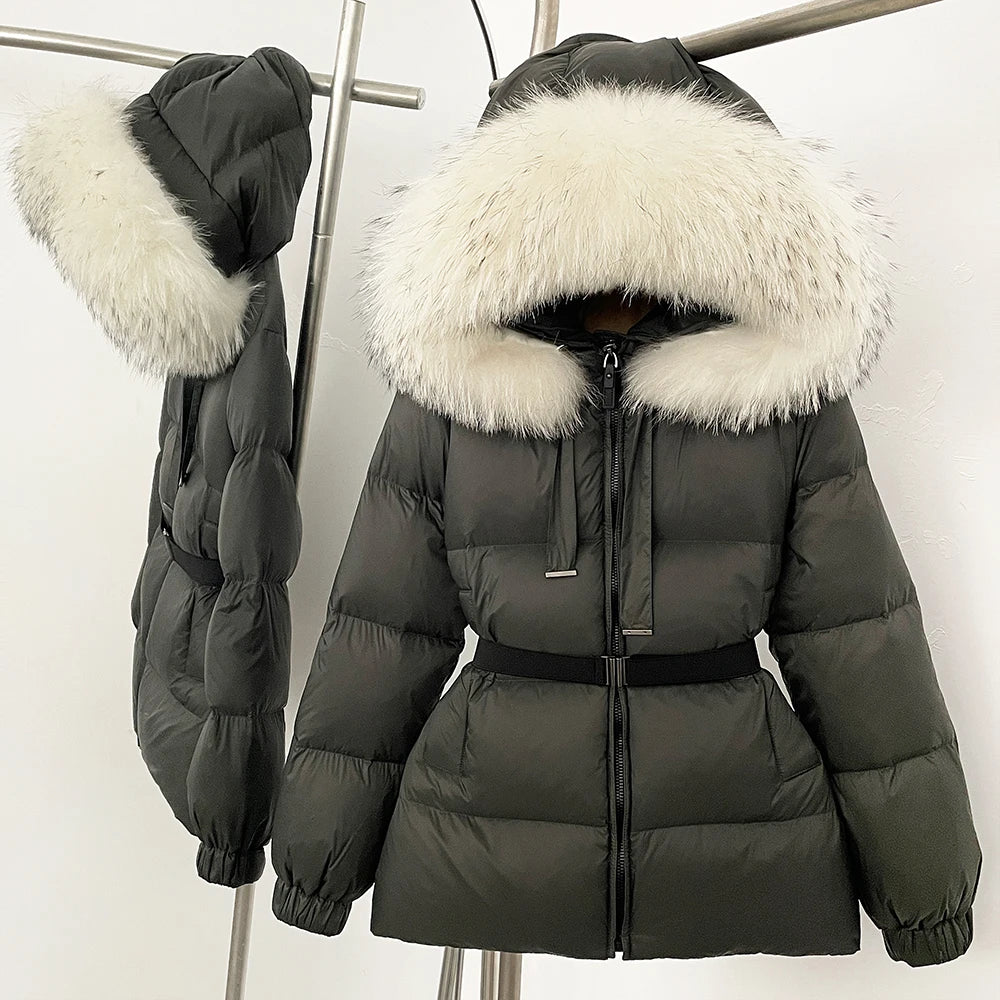 Dark green puffer jacket with white fur hood on a stand against a white background