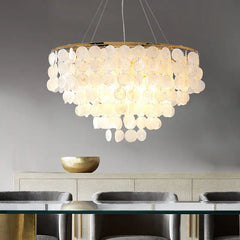 Chandelier with shell-like design in a dining room setting