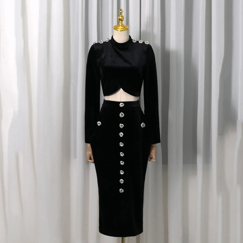 Black velvet embellished crop top and high-slit midi skirt displayed on a mannequin.