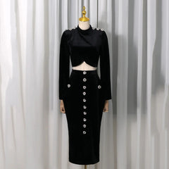 Black velvet embellished crop top and high-slit midi skirt displayed on a mannequin.