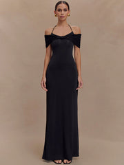 Woman wearing a black off-shoulder gown against a beige background